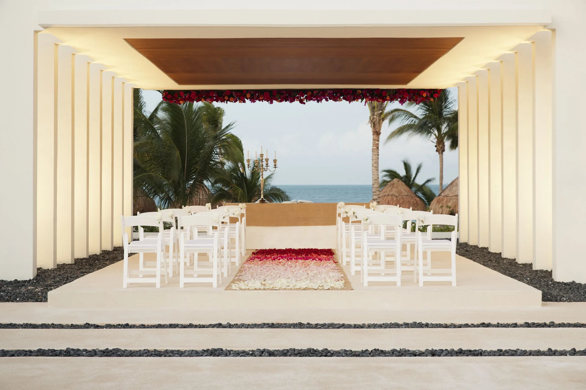 Ocean-view wedding ceremony setup with white chairs at Finest Playa Mujeres.