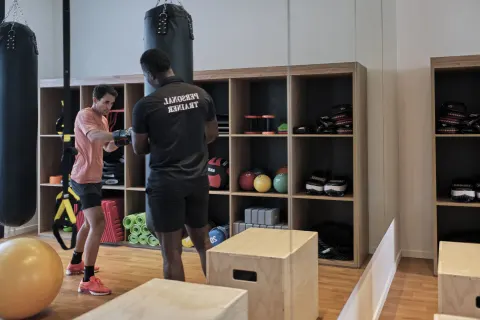 Personal trainer guiding a boxing workout in the gym at Finest Punta Cana.