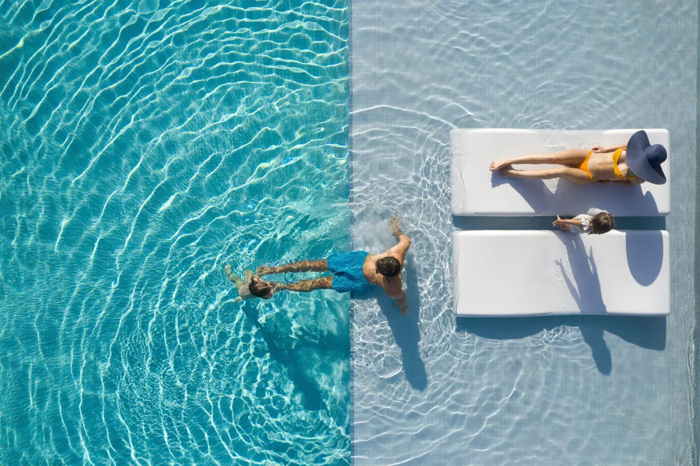 Overhead pool scene with family and in-water loungers at Finest Punta Cana.