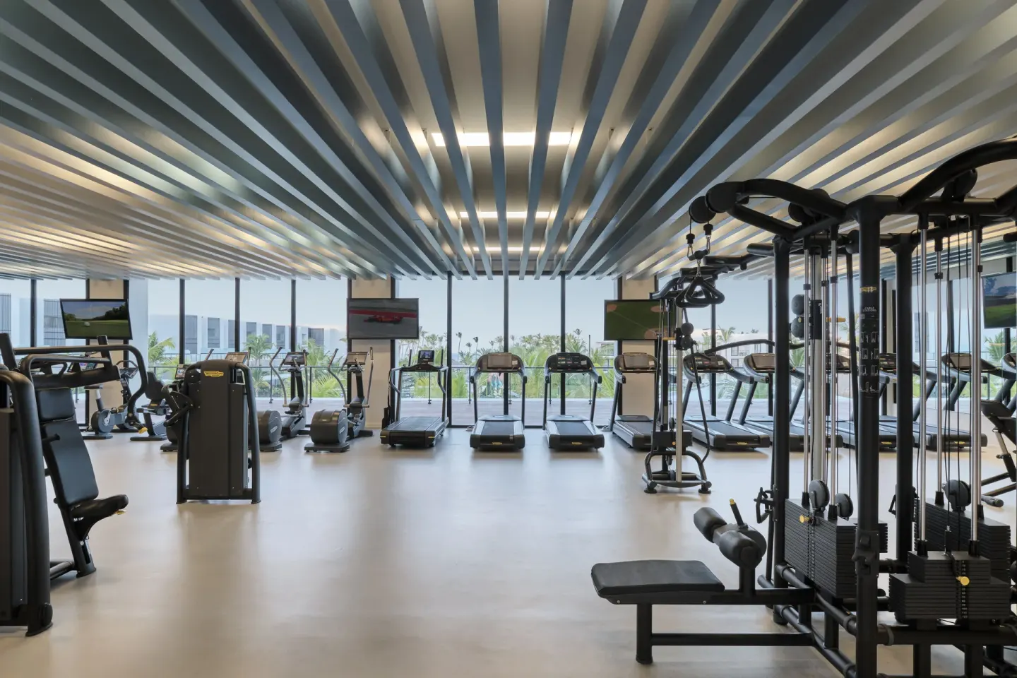 Spacious fitness center with treadmills and weight machines at Finest Punta Cana.