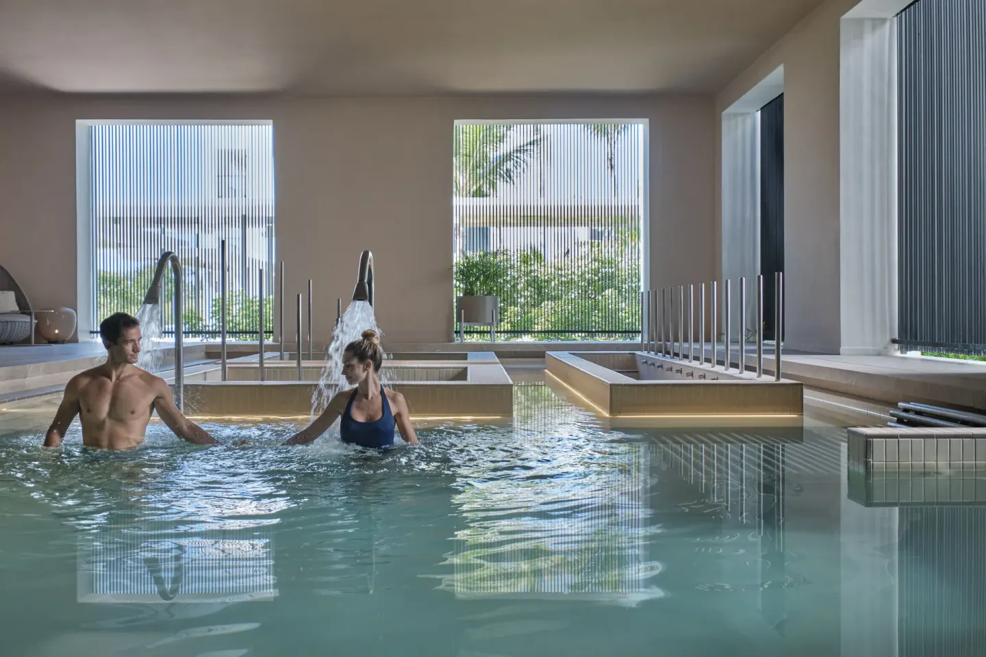 Couple in an indoor spa pool with water features at Finest Punta Cana.