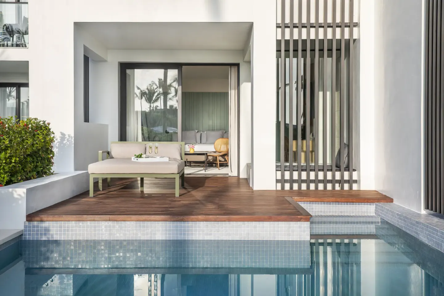 Swim-up suite terrace with daybed and pool access at Finest Punta Cana.