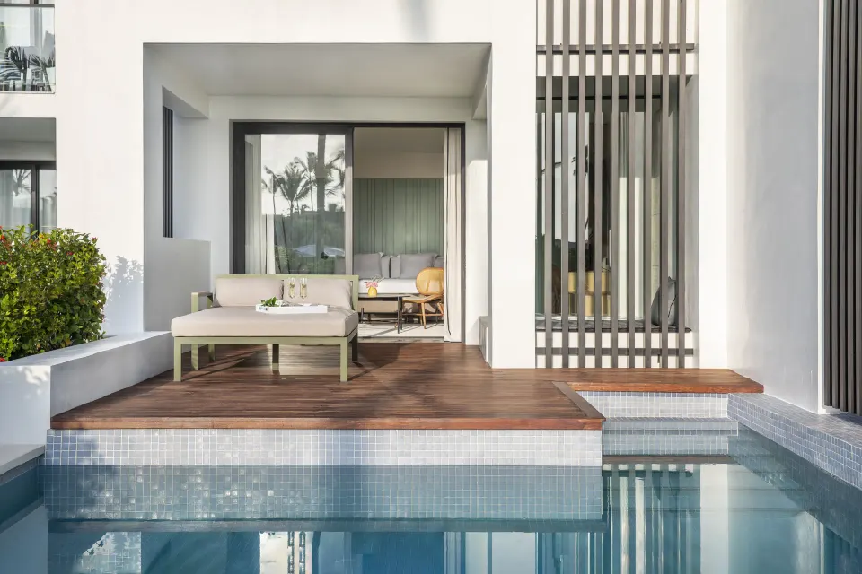Swim-up suite terrace with daybed and pool access at Finest Punta Cana.
