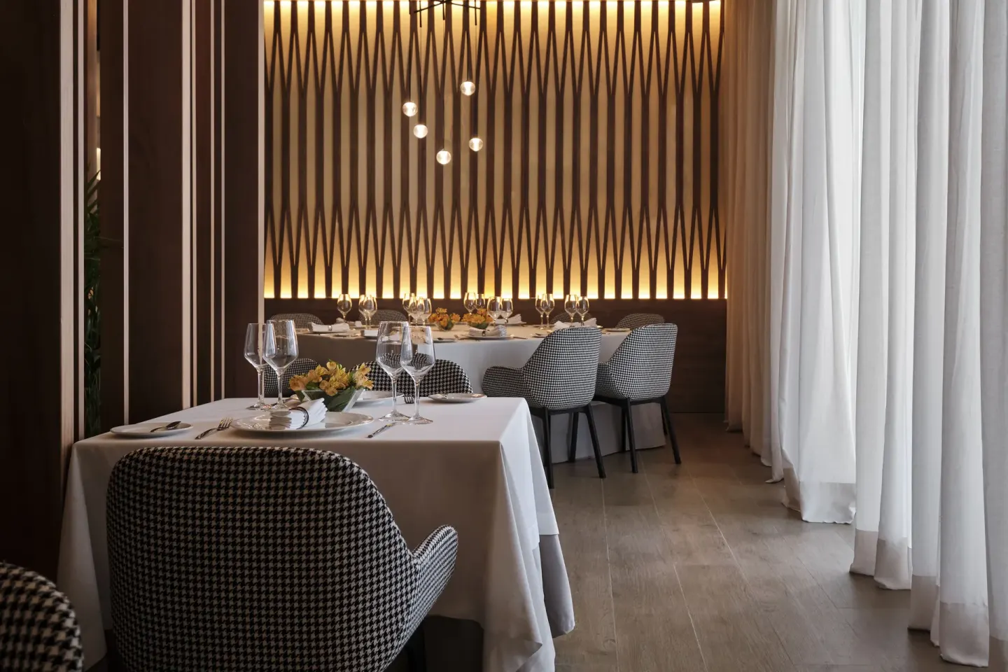 Formal dining room with white linens and patterned chairs at Finest Punta Cana.