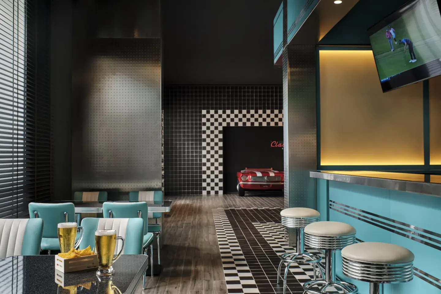 Sports bar with turquoise stools, TV screens, and checkered tile at Finest Punta Cana.