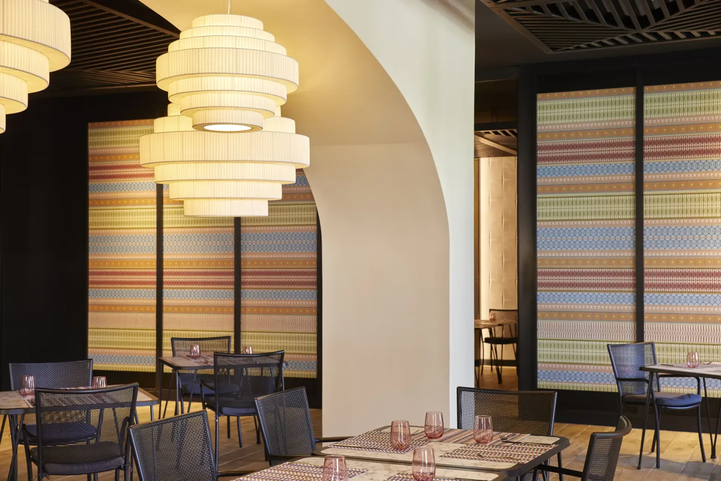 Modern dining room with pendant lights and patterned walls at Finest Punta Cana.