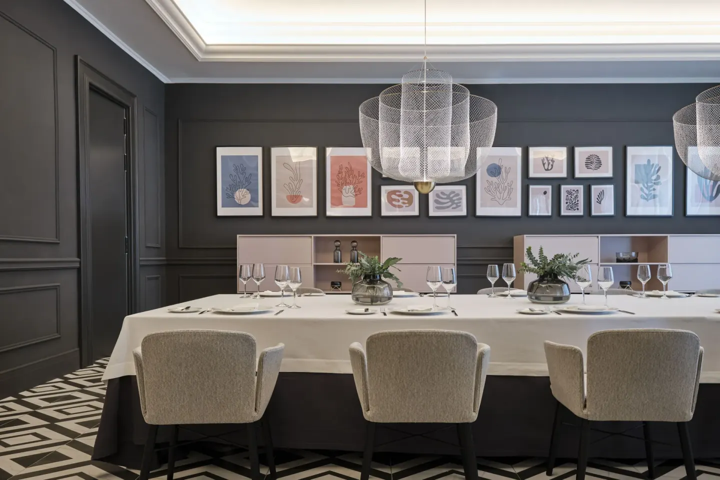Private dining room with a long set table and framed artwork at Finest Punta Cana.