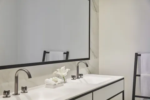 Double-sink bathroom vanity with mirror and towels in a Pool View room at Finest Punta Cana.
