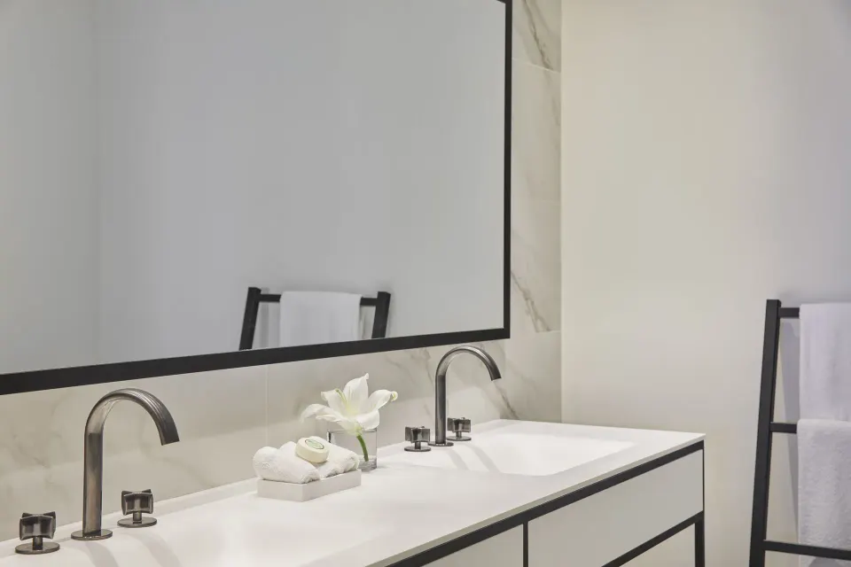 Double-sink bathroom vanity with mirror and towels in a Pool View room at Finest Punta Cana.
