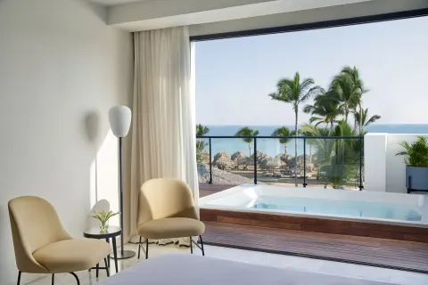 Plunge pool terrace off a guest room at Finest Punta Cana with chairs and ocean view.