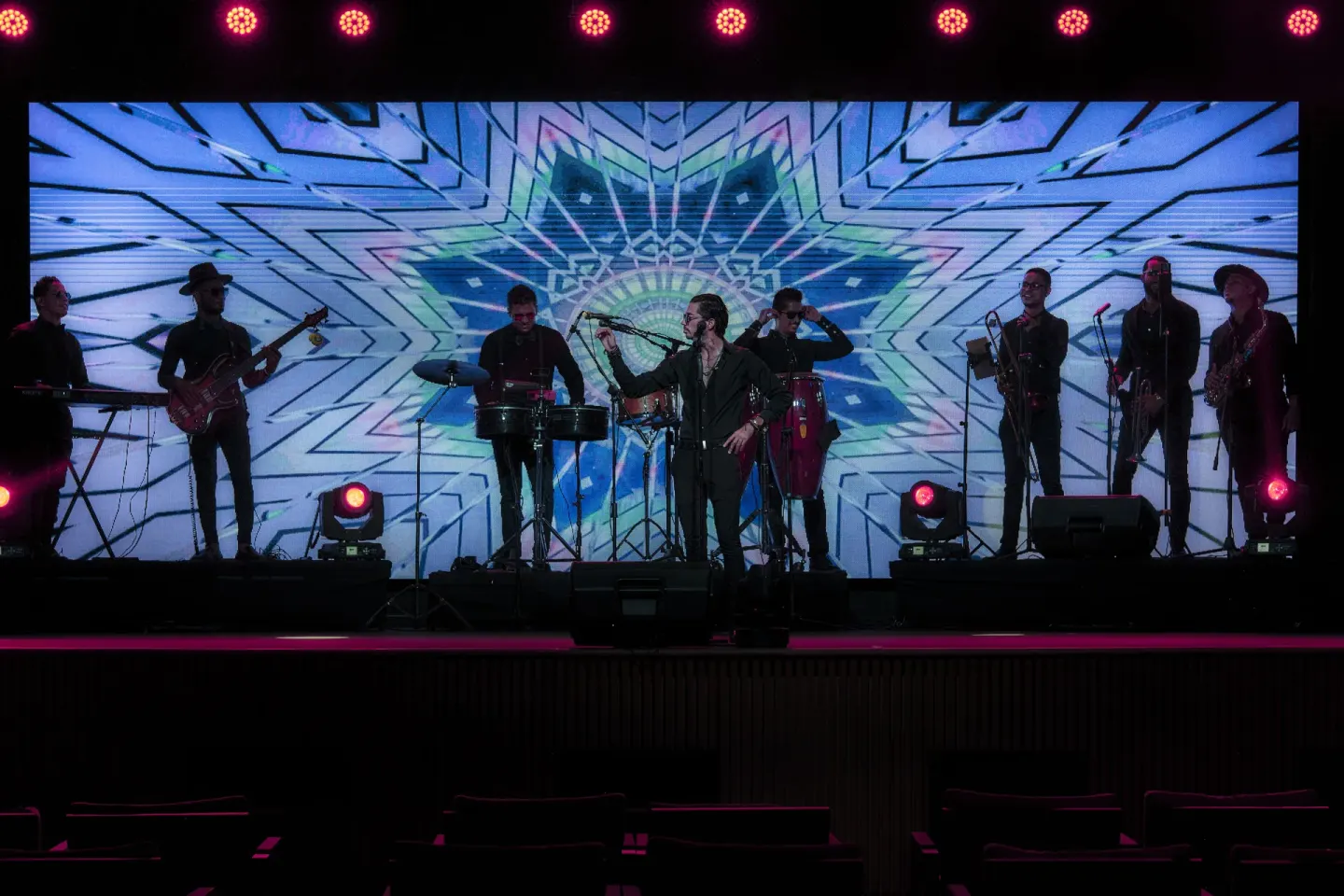 Live band performs on a theater stage with colorful lights at Finest Punta Cana.