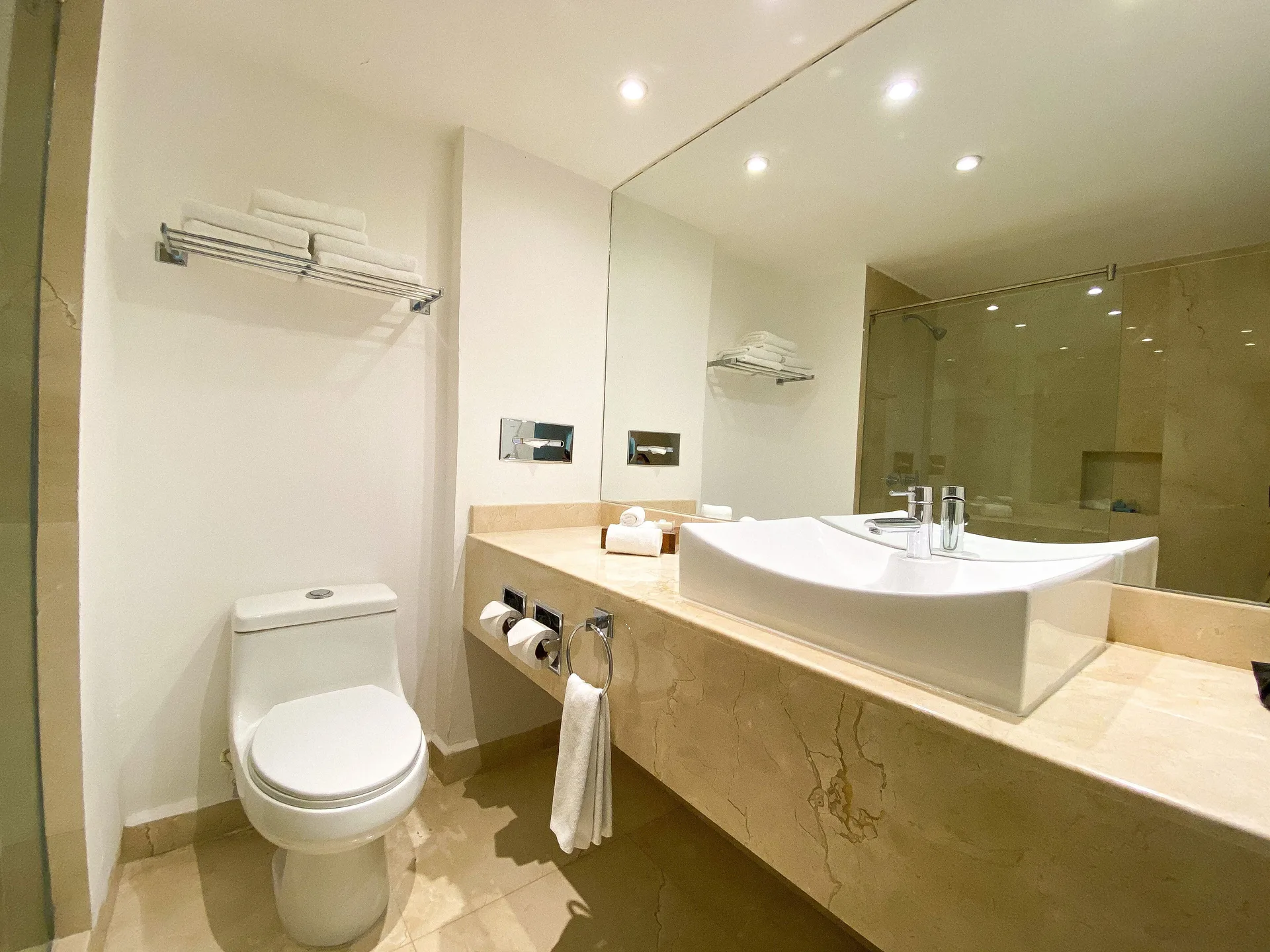 Bathroom with vessel sink, toilet and glass shower at Flamingo Cancun.