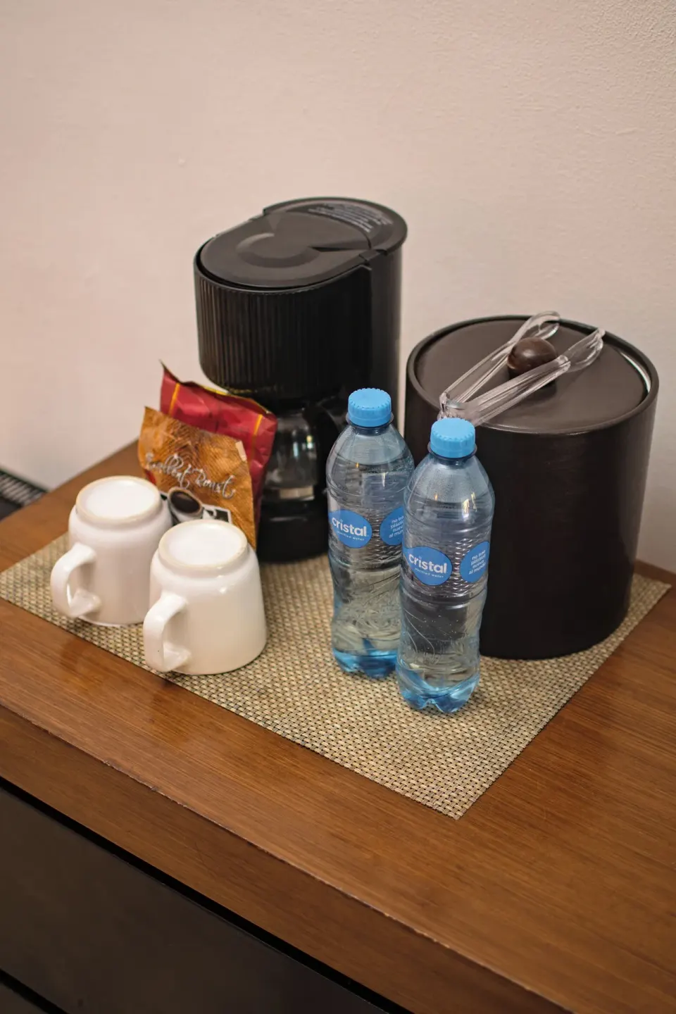 Coffee maker, ice bucket, mugs, and bottled water in a room at Flamingo Cancun.