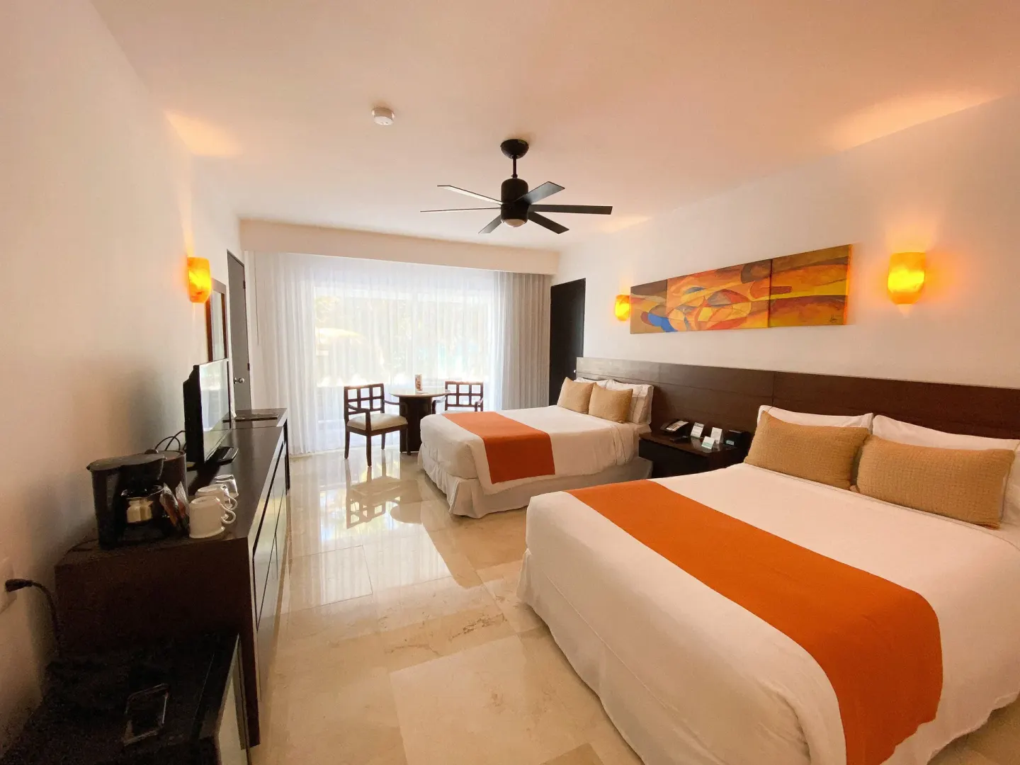 Guest room with two beds, coffee station, and window seating at Flamingo Cancun.