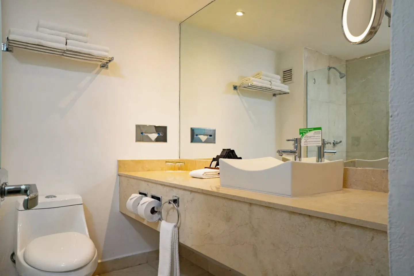 Deluxe Pool Terrace Walkout bathroom with toilet, vanity and towel shelf at Flamingo Cancun.