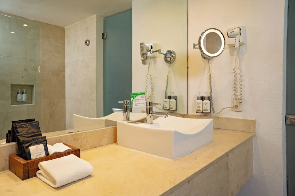 Deluxe Pool Terrace Walkout bathroom vanity with sink and mirror at Flamingo Cancun.