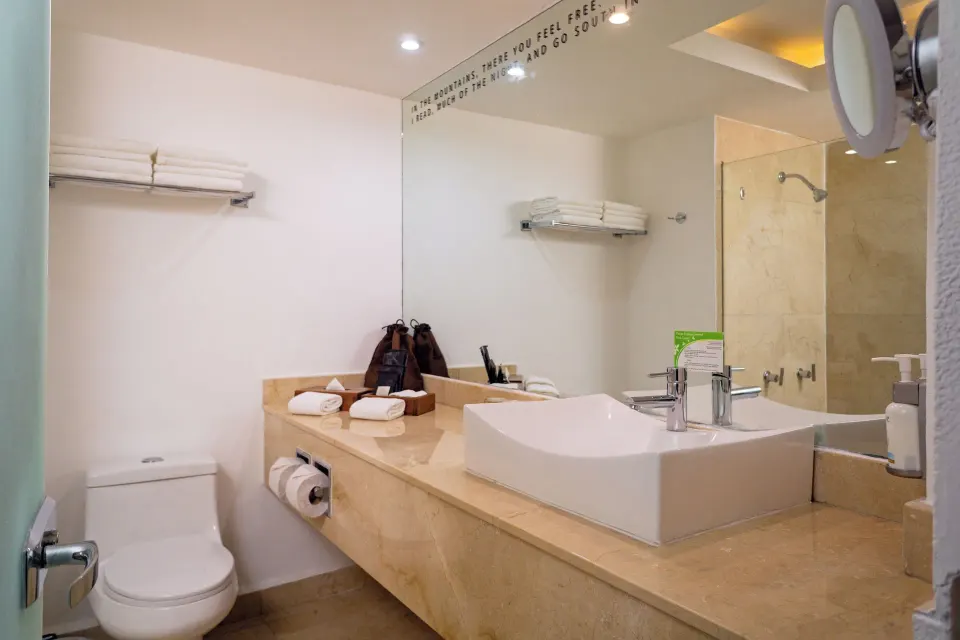 Jr Suite Swim Up Ocean View bathroom vanity and shower at Flamingo Cancun.