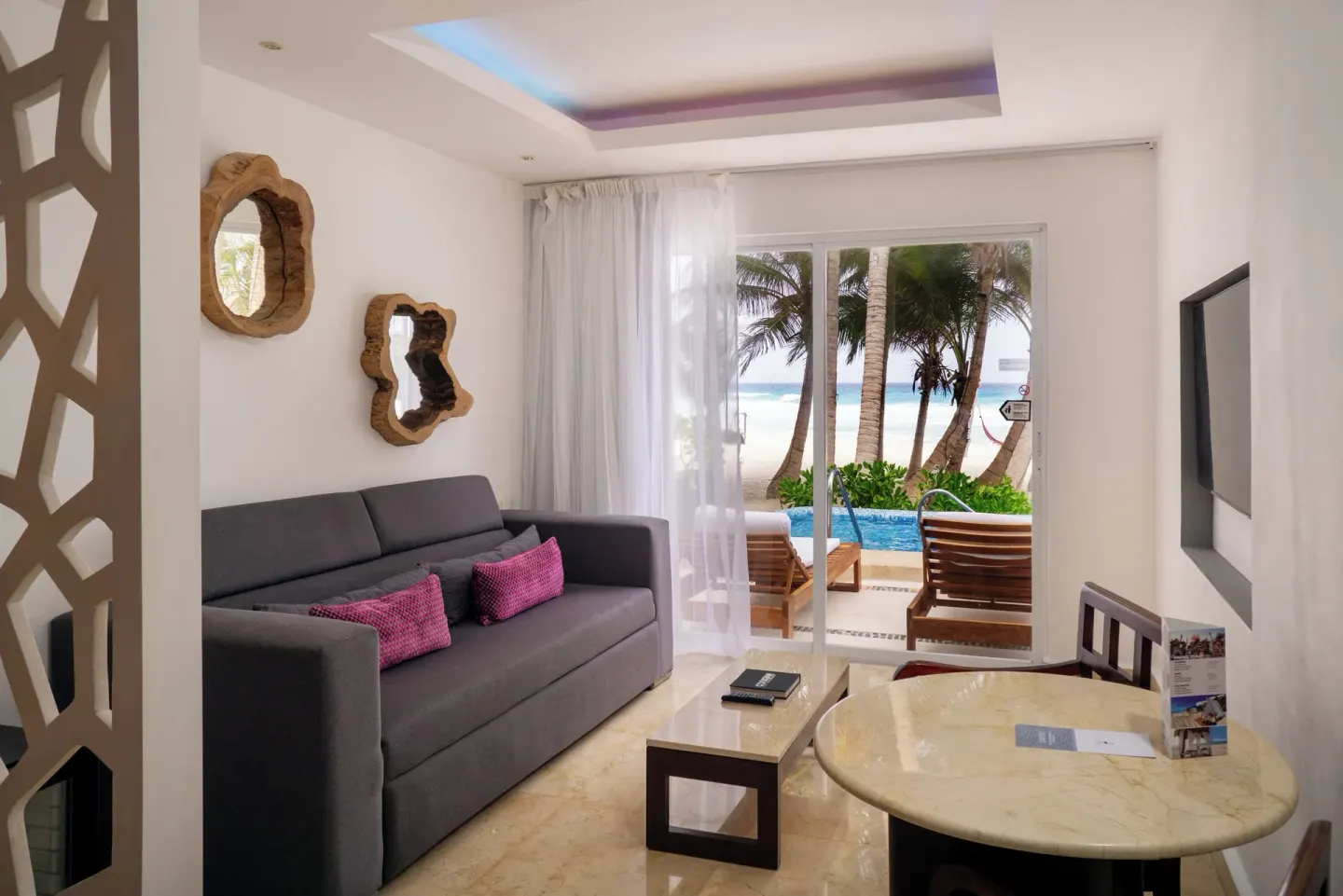Jr Suite Swim Up Ocean View lounge with patio pool access at Flamingo Cancun.