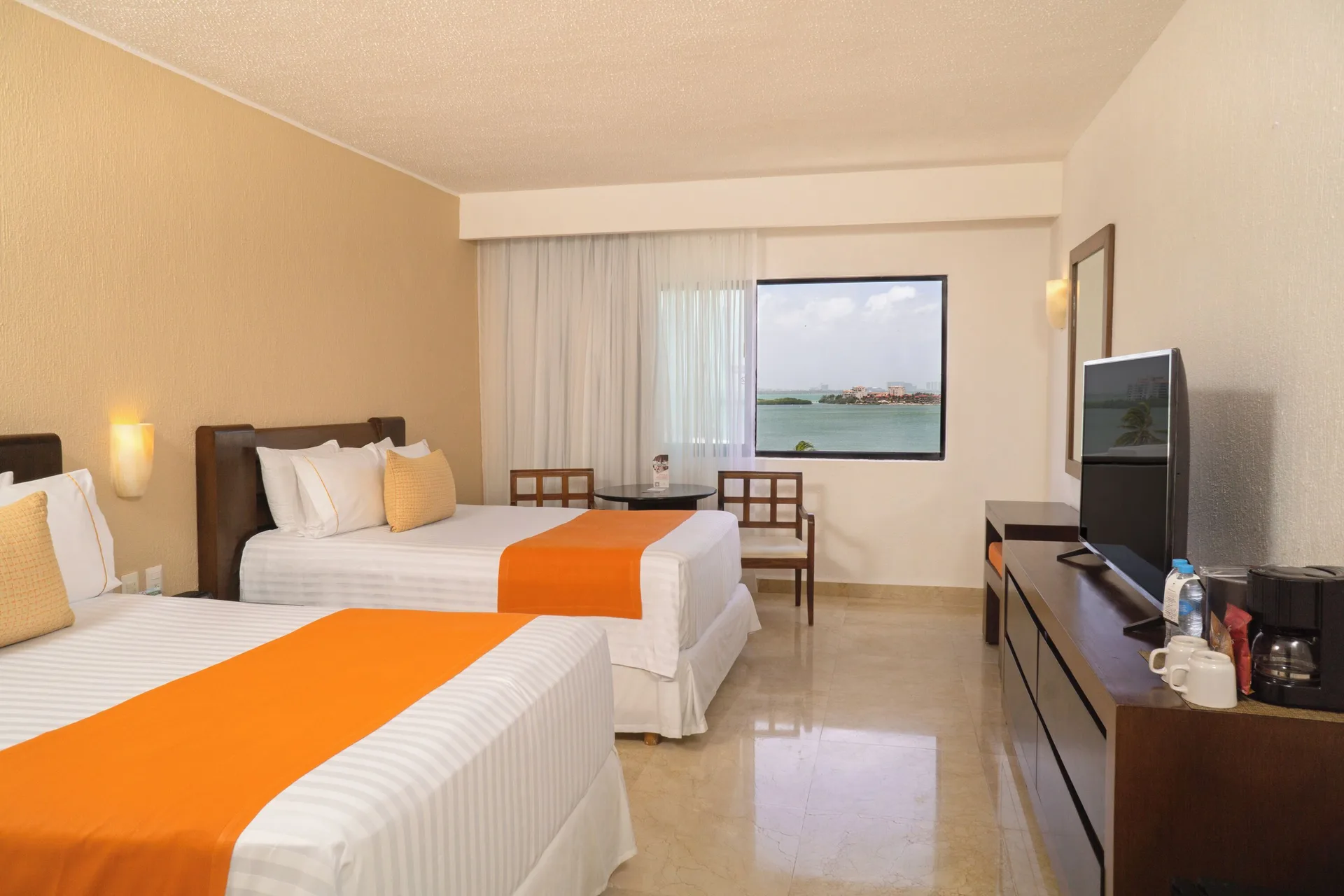 Standard Room Lagoon View with two double beds and window view at Flamingo Cancun.