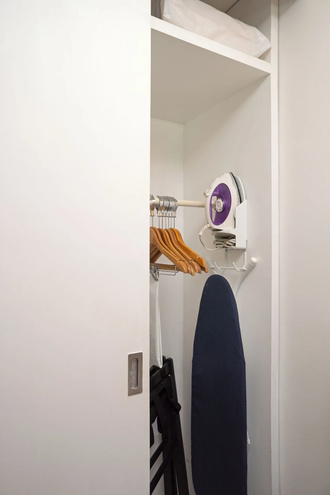 Standard Room closet with hangers, iron, and ironing board at Flamingo Cancun.