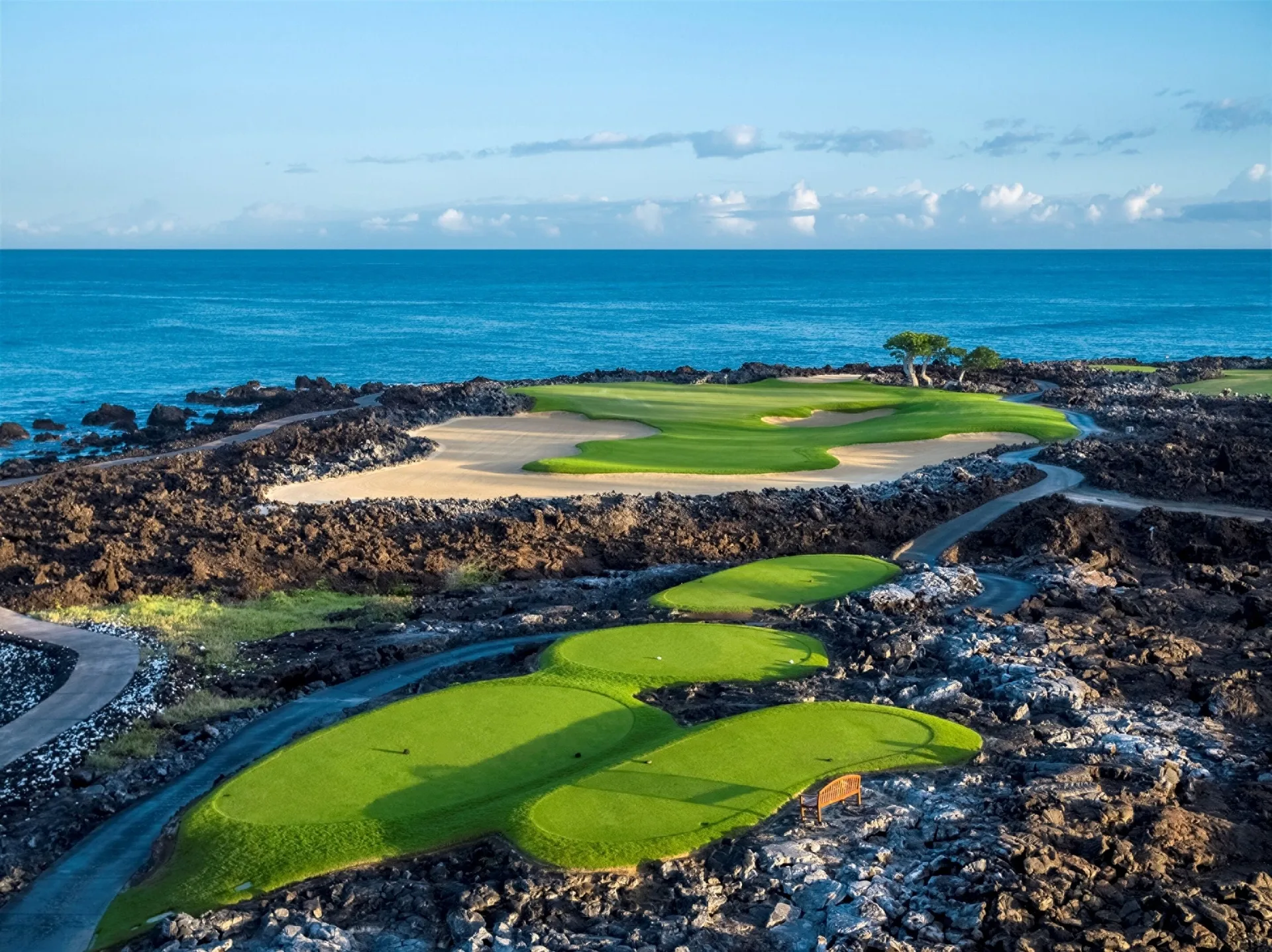 Aerial view of oceanfront golf holes at Four Seasons Resort Hualalai.