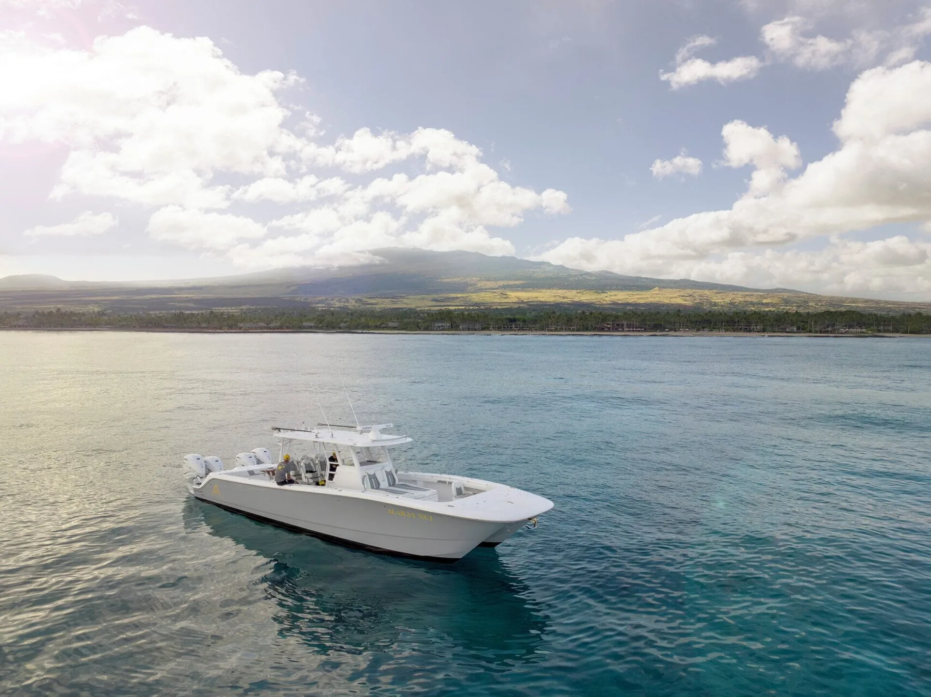 White boat floating offshore near Four Seasons Resort Hualalai.