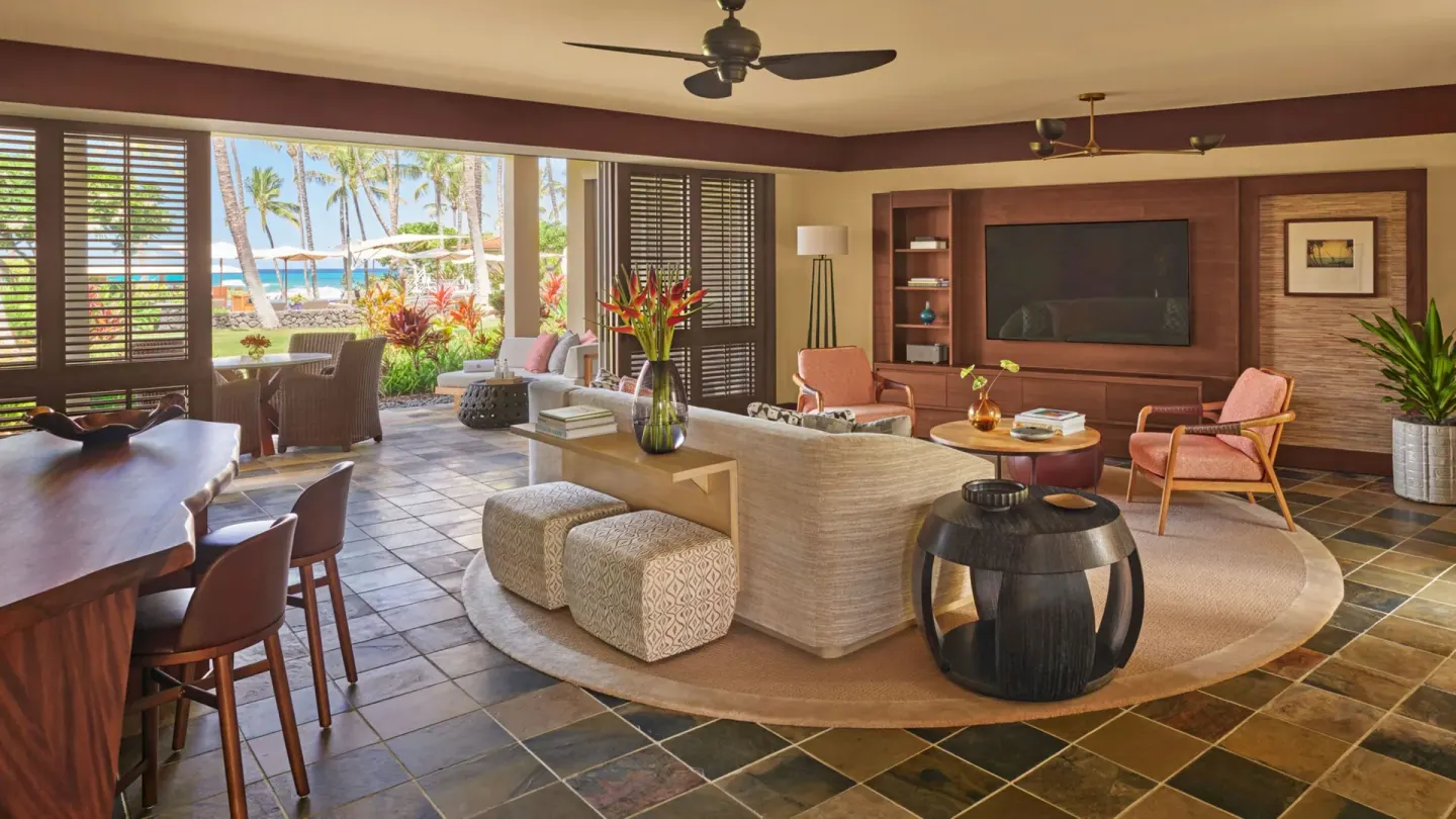 Garden-level suite living room with ocean beyond at Four Seasons Resort Hualalai.