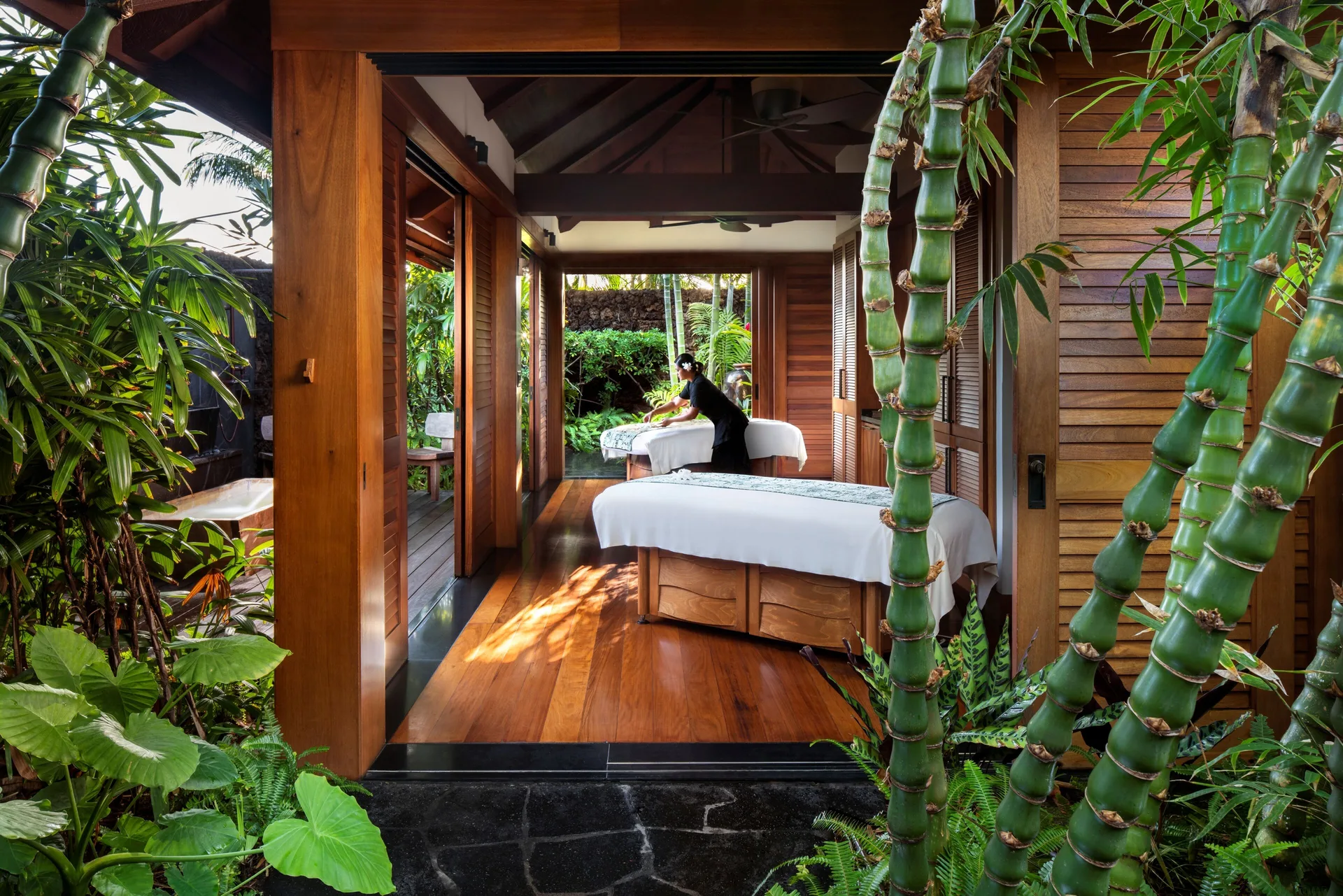 Open-air spa treatment room with massage tables at Four Seasons Resort Hualalai.