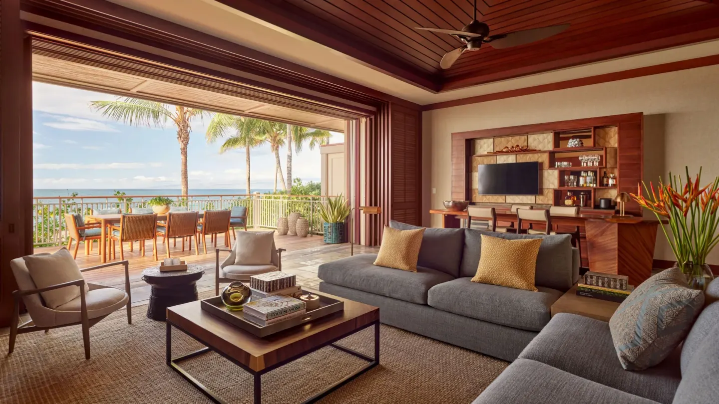 Suite living room with terrace and ocean view at Four Seasons Resort Hualalai.