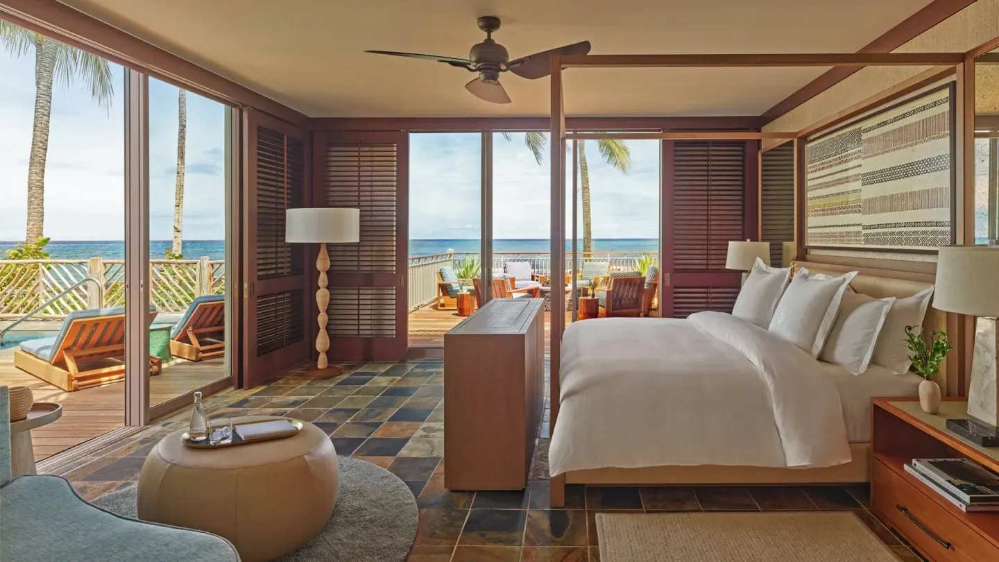 Oceanfront bedroom with king bed and terrace at Four Seasons Resort Hualalai.
