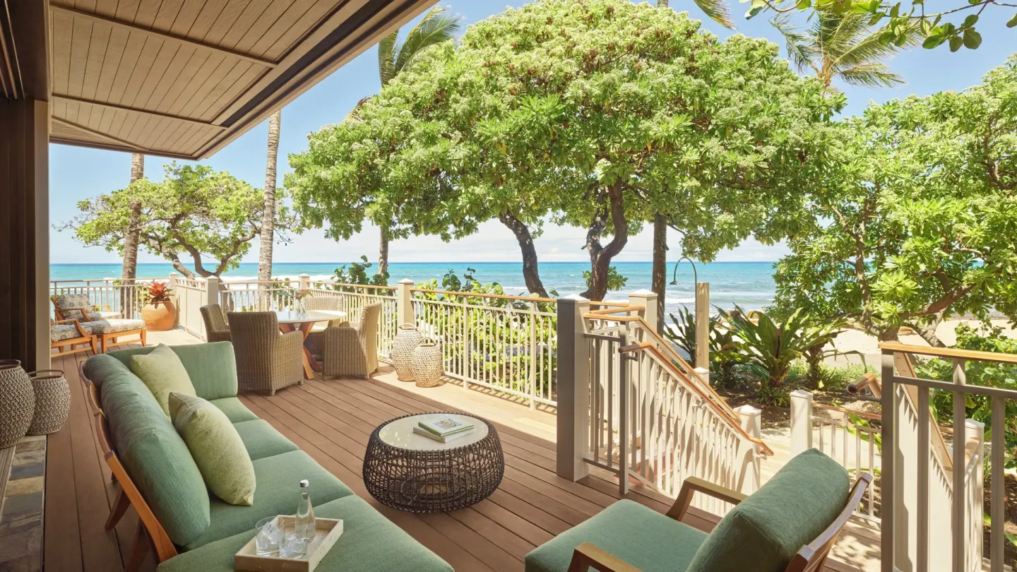 Oceanfront lanai seating with beach views at Four Seasons Resort Hualalai.