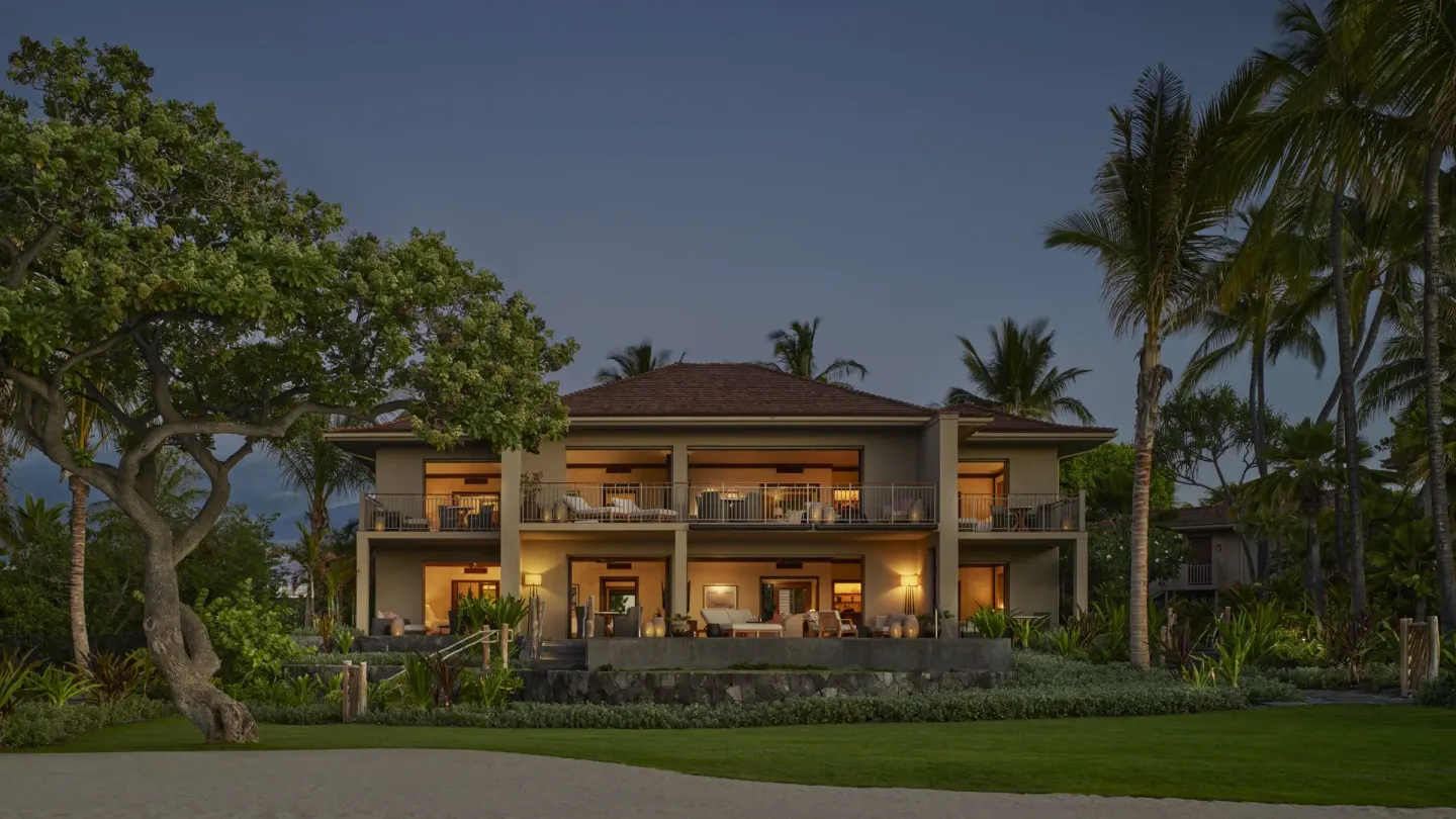 Two-story oceanfront resort building at dusk at Four Seasons Resort Hualalai.
