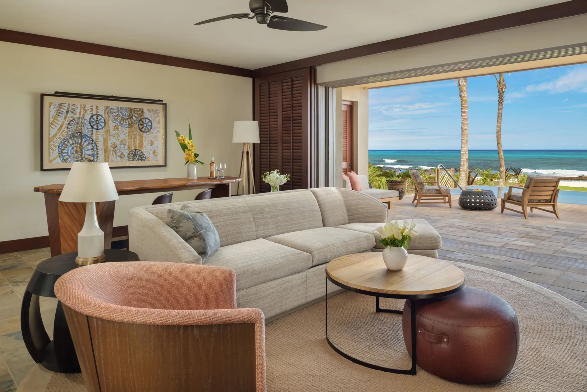 Suite living room with patio and ocean view at Four Seasons Resort Hualalai.