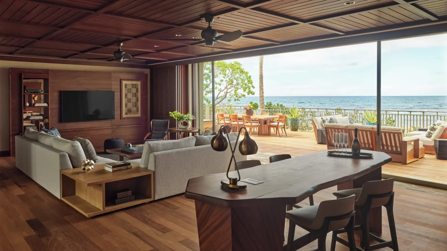 Oceanfront suite living room with open deck and dining terrace at Four Seasons Resort Hualalai.