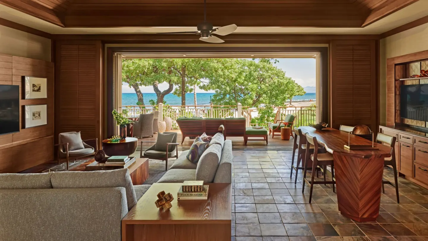 Oceanfront villa living room with open lanai at Four Seasons Resort Hualalai.