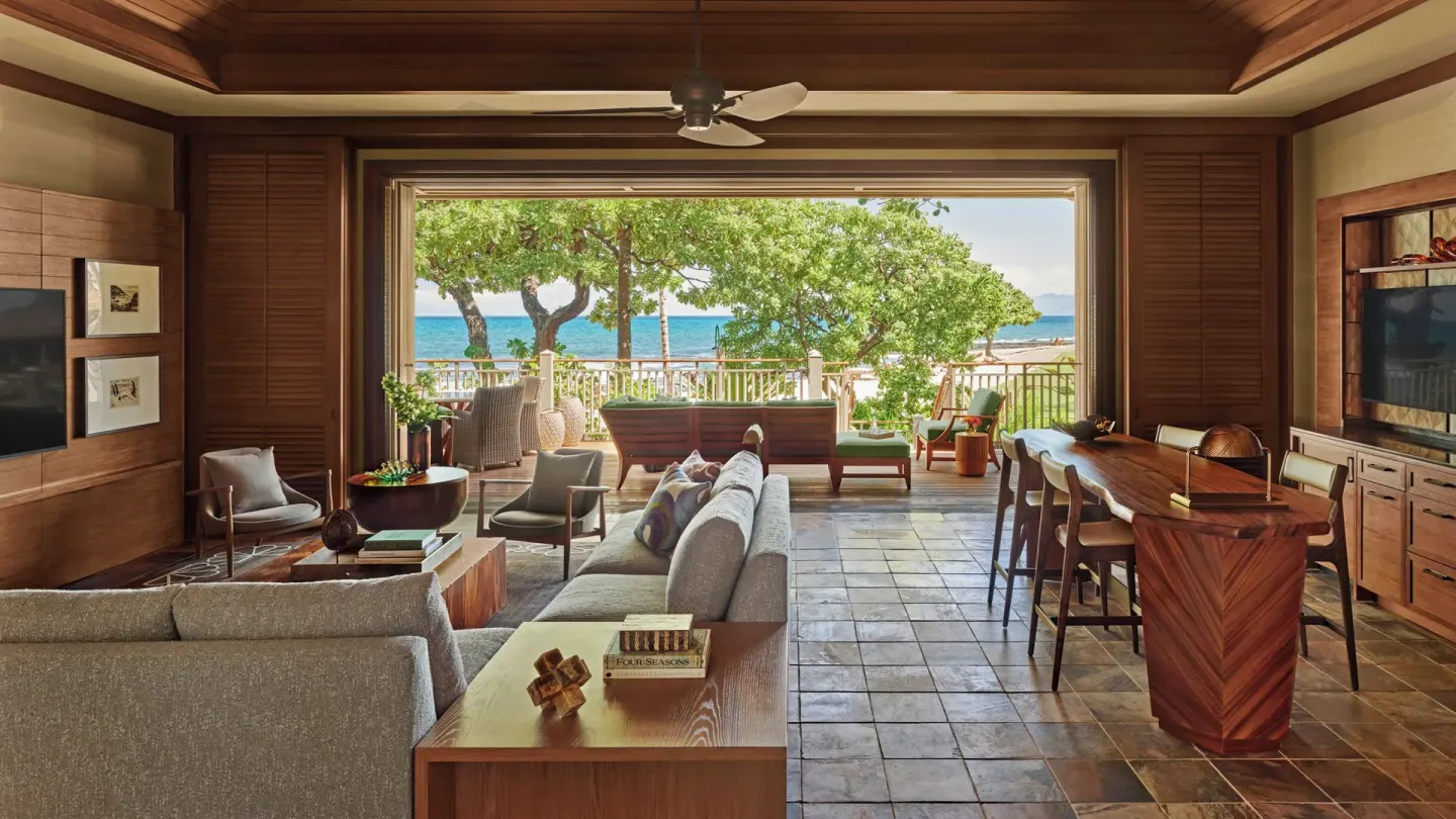 Open-plan villa living room facing the ocean at Four Seasons Resort Hualalai.