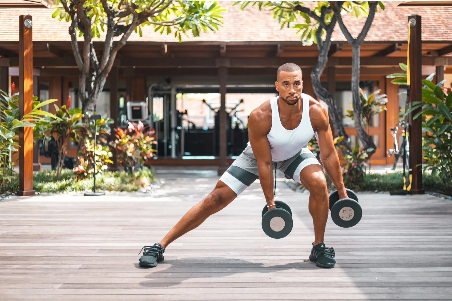 Man exercising with dumbbells outdoors at Four Seasons Resort Hualalai.