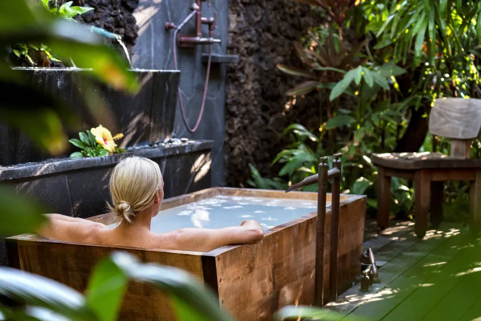 Outdoor soaking tub in a tropical spa garden at Four Seasons Resort Hualalai.
