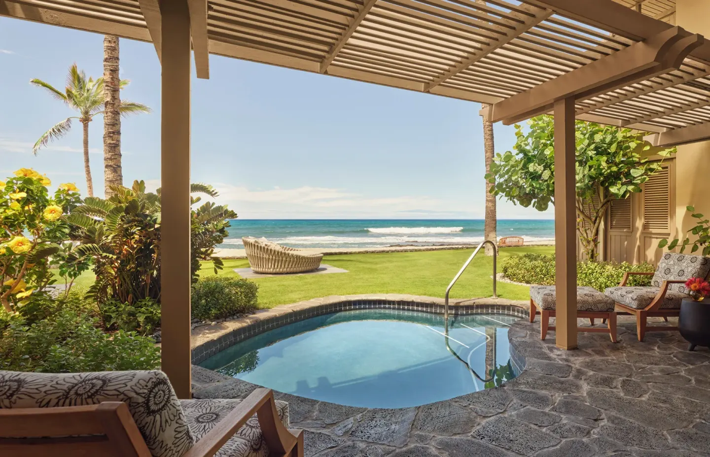 Private plunge pool and shaded patio facing the ocean at Four Seasons Resort Hualalai.