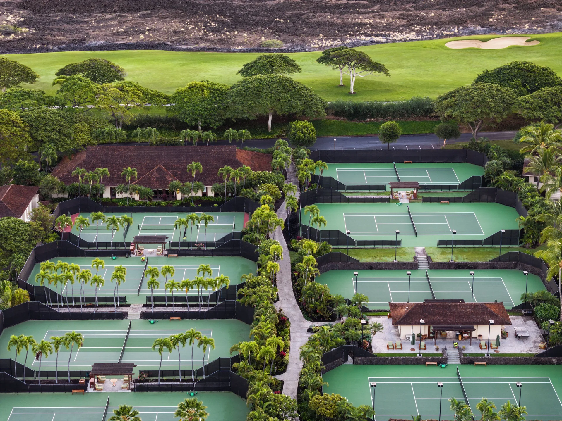 Aerial view of tennis courts and golf greens at Four Seasons Resort Hualalai.