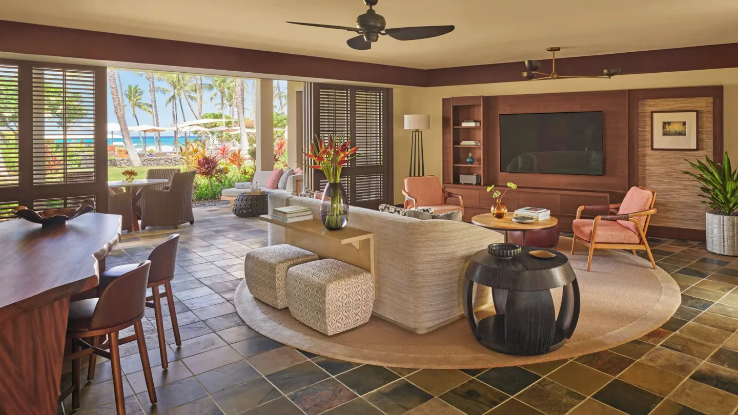 Suite living room with open patio doors at Four Seasons Resort Hualalai.