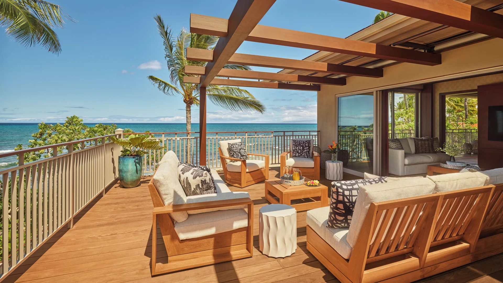Upper-level oceanfront deck with lounge seating at Four Seasons Resort Hualalai.