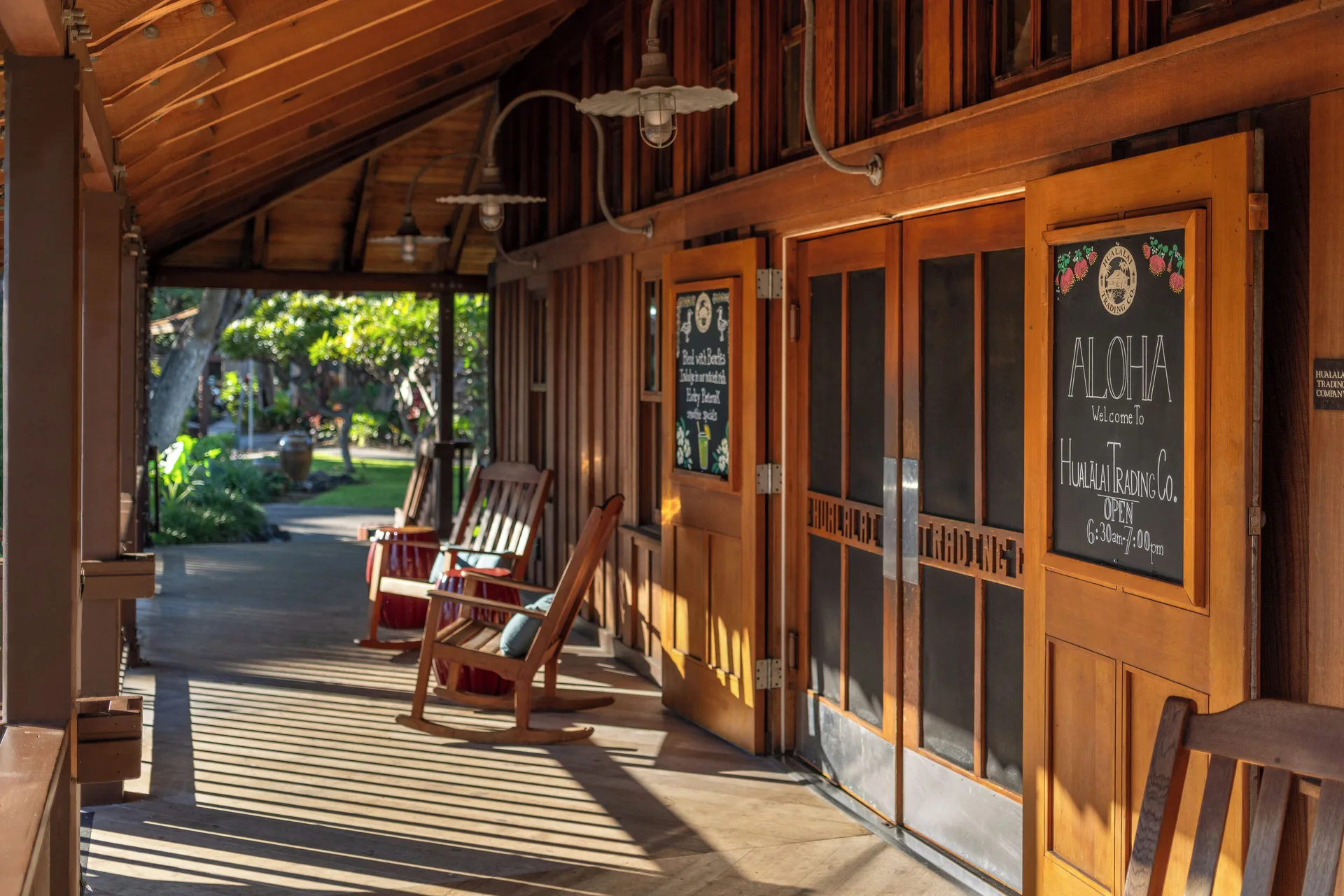 Hualalai Trading Company exterior walkway at Four Seasons Resort Hualalai with rocking chairs.