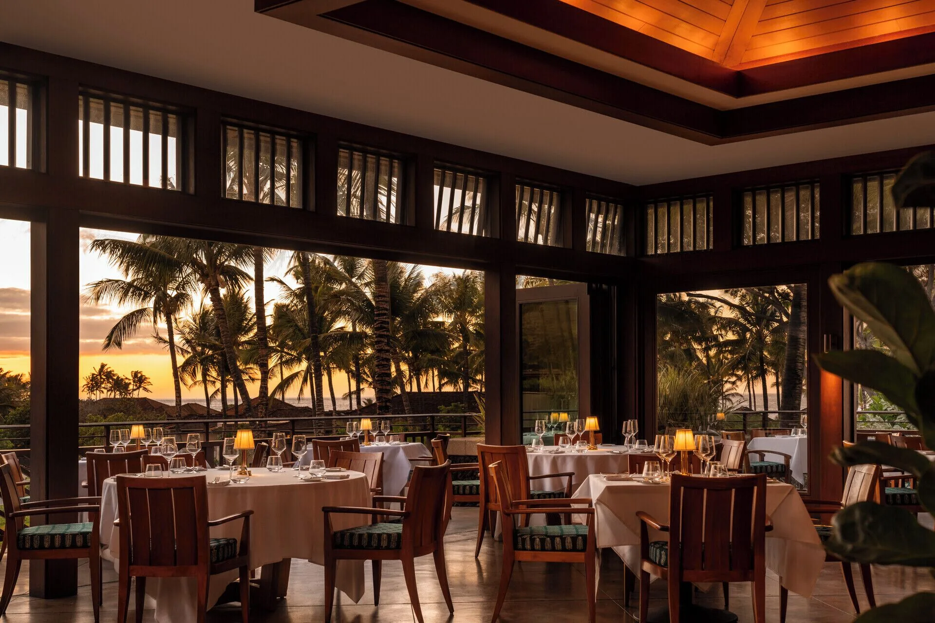 Oceanview dining room set for dinner at Four Seasons Resort Hualalai.