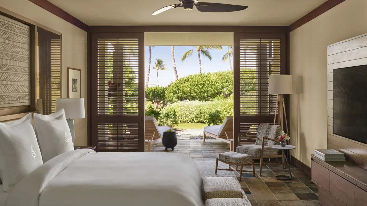 King bedroom with garden patio in an ohana family suite at Four Seasons Resort Hualalai.