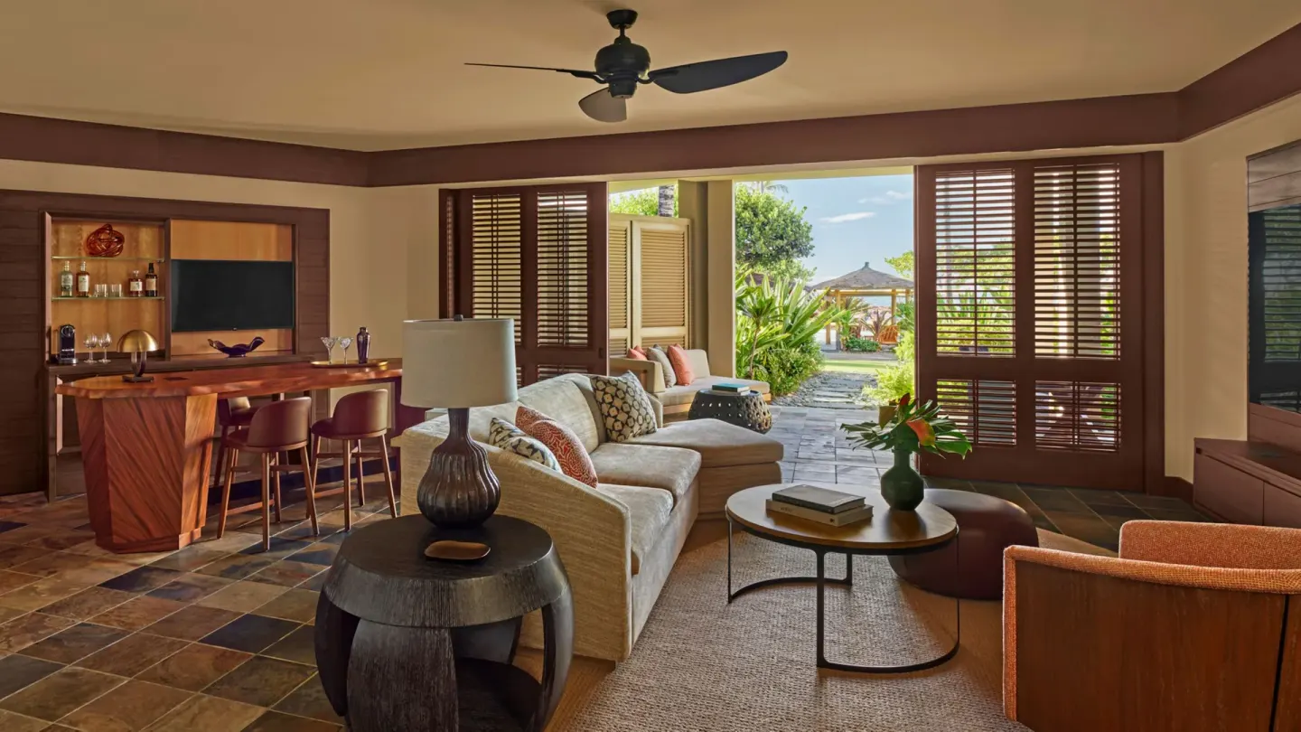 Garden-view living room in an ohana family suite at Four Seasons Resort Hualalai.