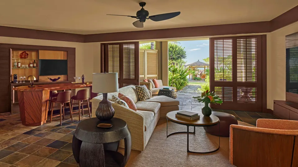 Garden-view living room in an ohana family suite at Four Seasons Resort Hualalai.