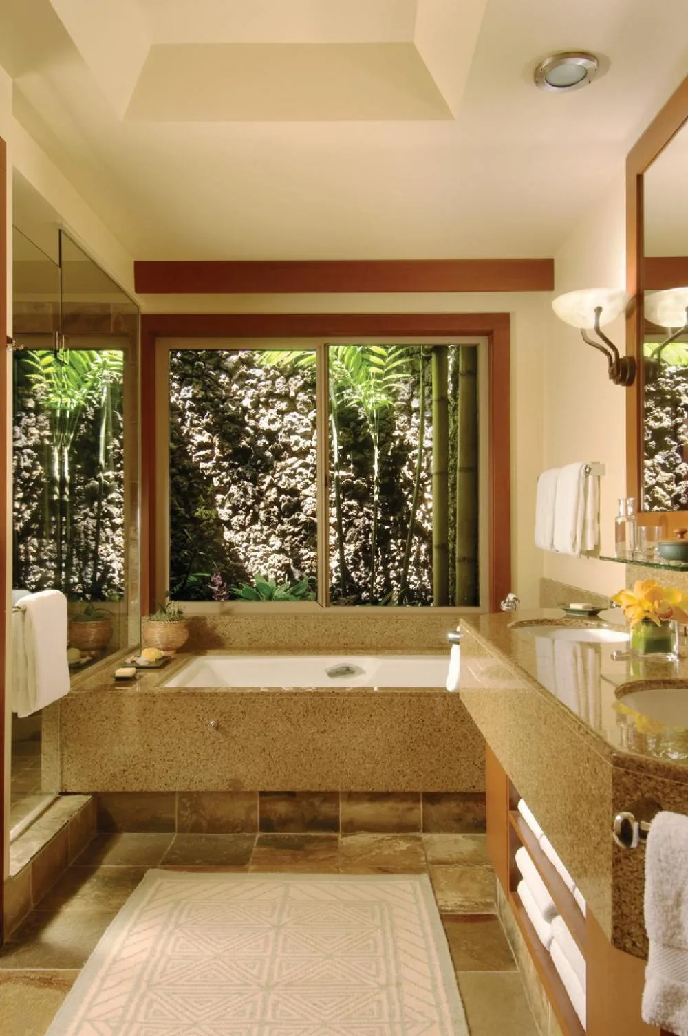 Poolside accessible room bathroom with soaking tub at Four Seasons Resort Hualalai.