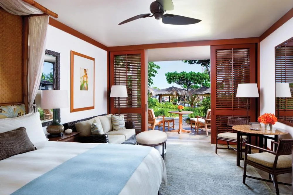 Poolside accessible room bed with lanai seating at Four Seasons Resort Hualalai.