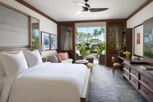 Poolside accessible room king bed and media console at Four Seasons Resort Hualalai.